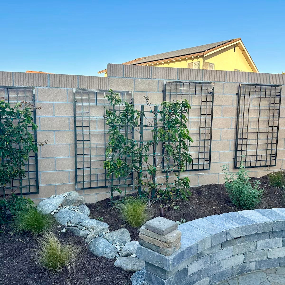 raw metal trellises on brick wall