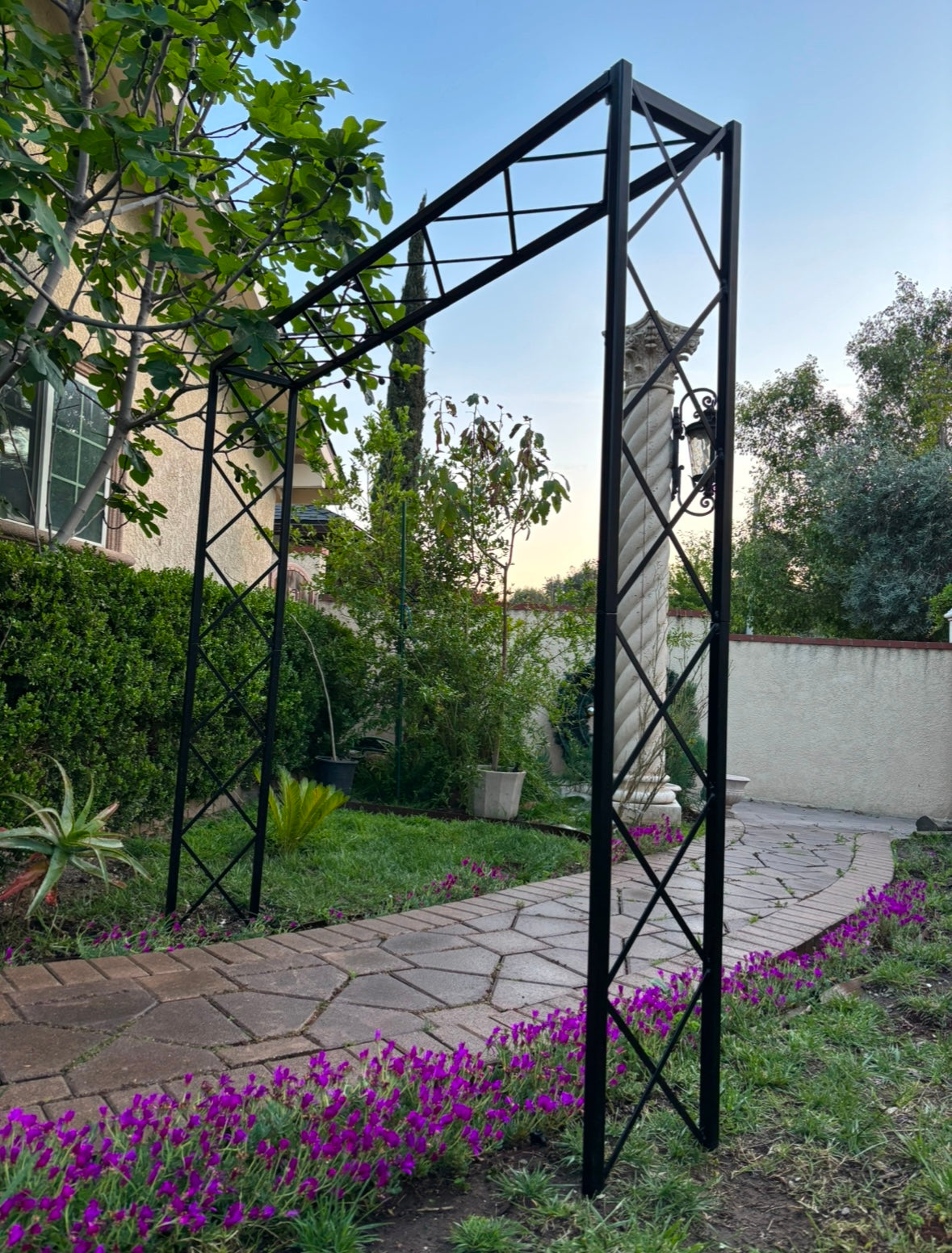 tall iron pergola with diamond trellis